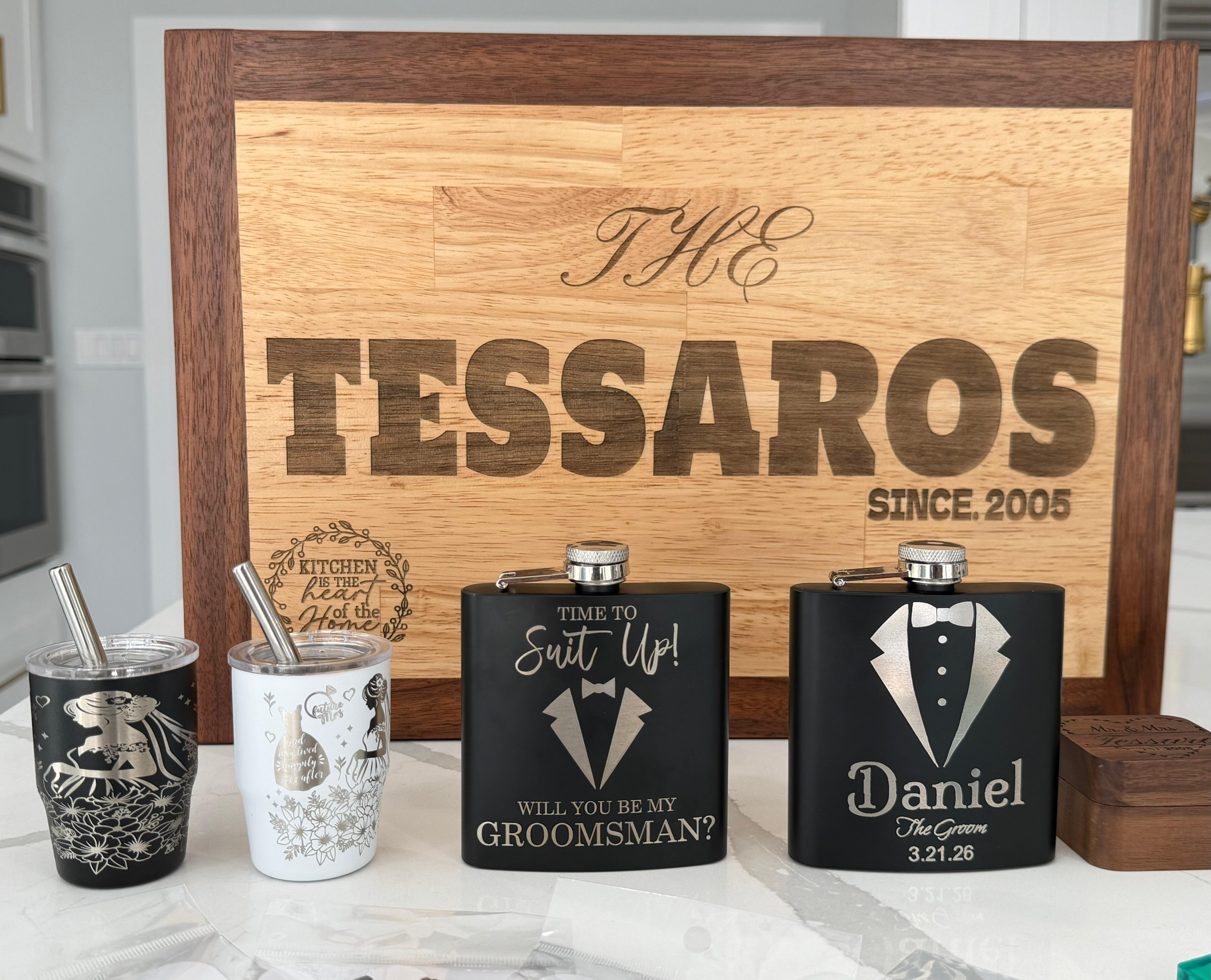 Tessaros wedding showcase with engraved board, tumblers and groom flasks